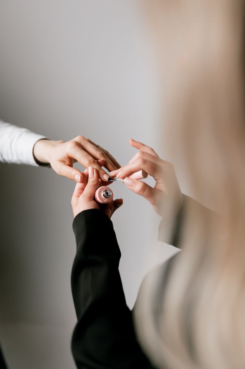 Free Hands-off nail polish application at a salon, highlighting detail and precision. Stock Photo